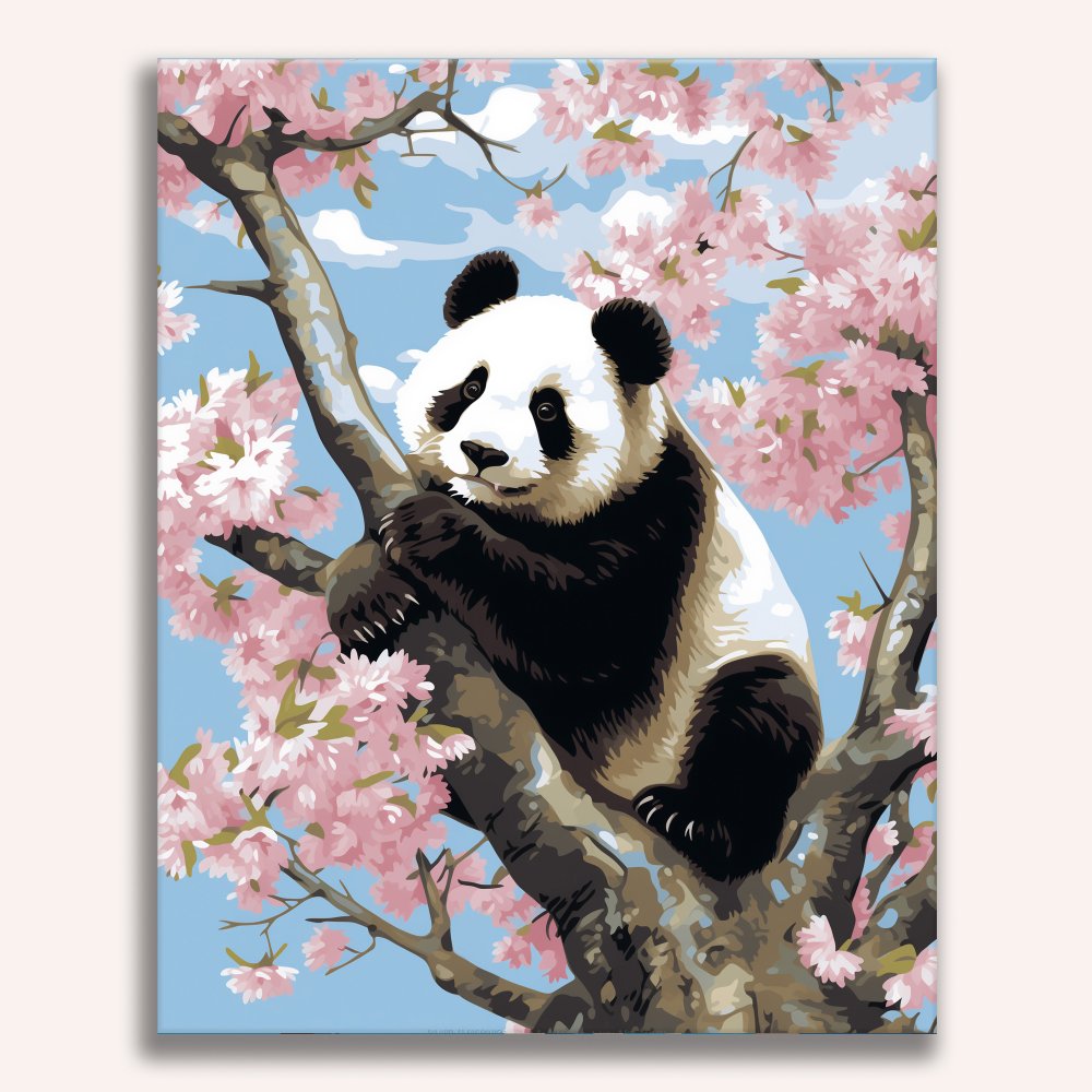 The image features a large, adult panda bear perched on a branch of a cherry blossom tree, which is situated against a clear blue sky..