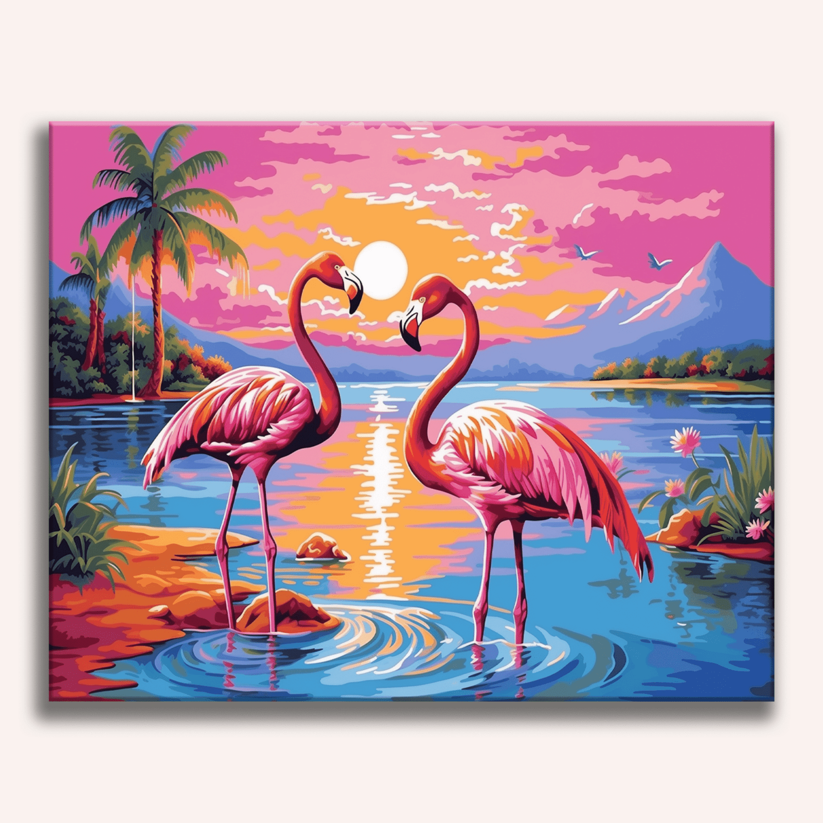 A pair of pink flamingos stand close together on the edge of a body of water at sunset or sunrise, with colorful sky and warm hues reflecting off the calm surface of the water.