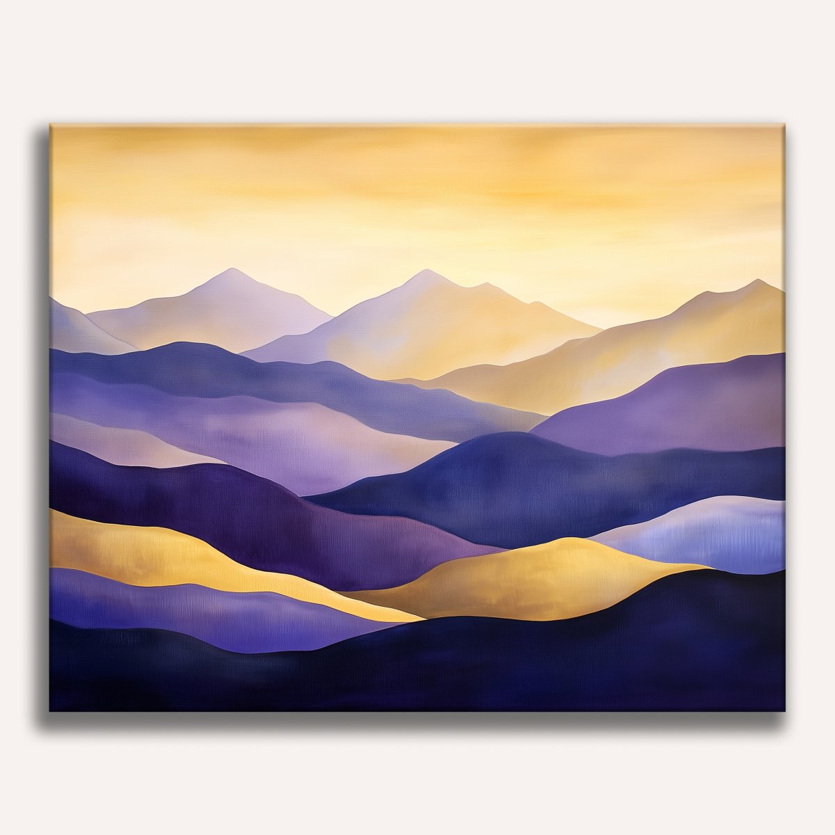 A canvas print of a mountainous landscape featuring a collection of purple and yellow hills or mountains under a warm, pale sky..