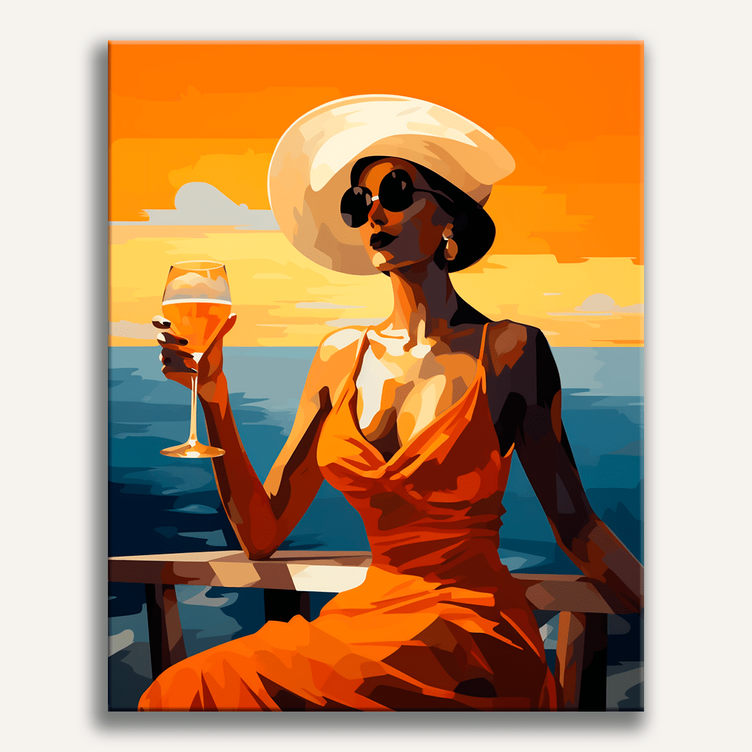 A woman in a vibrant red dress stands on a deck railing, holding a glass of white wine and overlooking a sunset or sunrise.