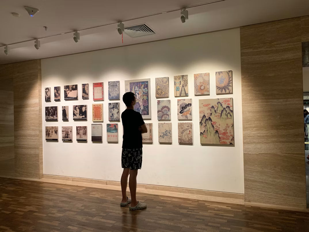 man looking at paintings