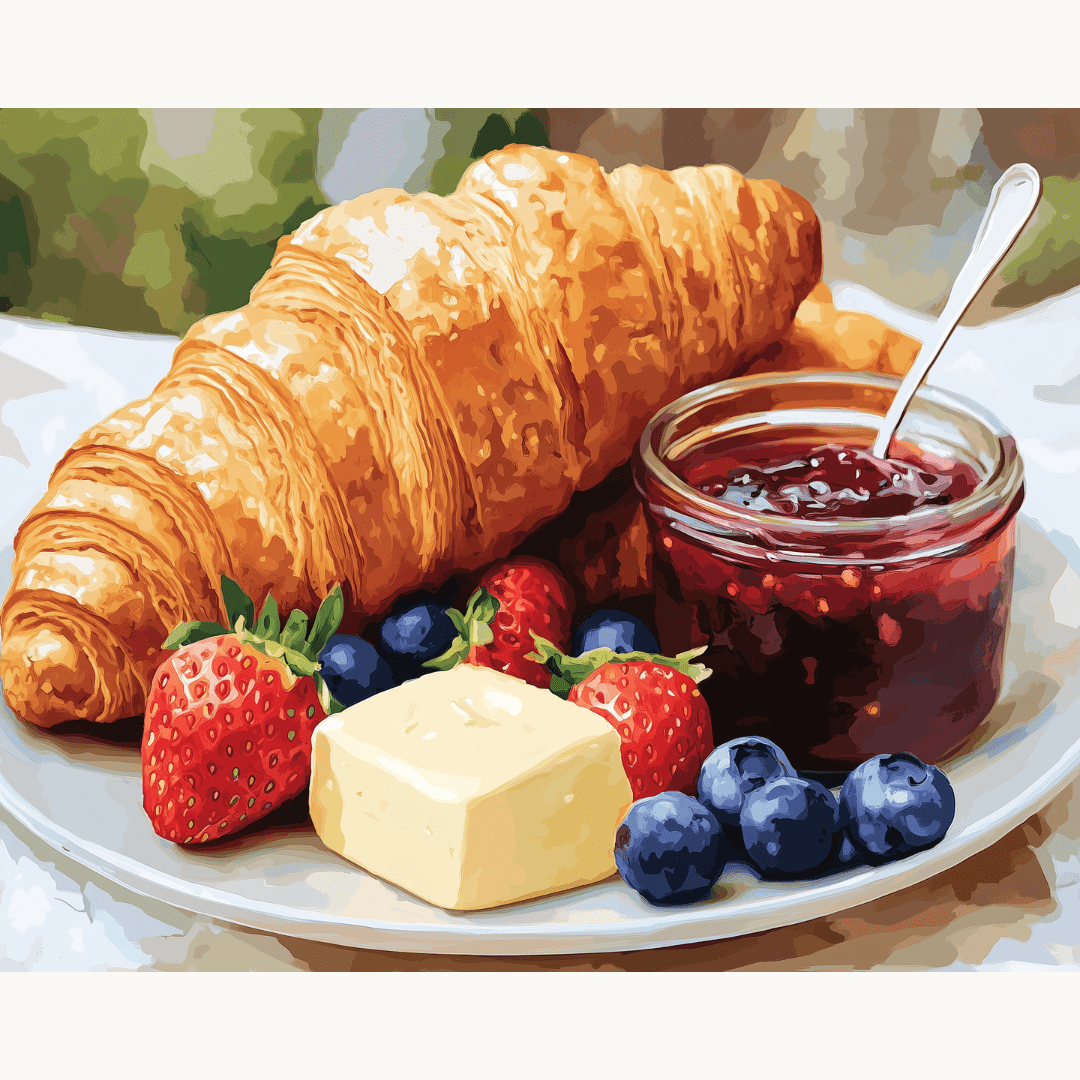 A plate filled with golden croissants is presented on a table.